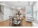 Bright dining area with hardwood floors and an elegant chandelier, open to a modern kitchen with a white countertop island at 423 State St, Charlotte, NC 28208