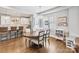 Bright dining room with hardwood floors, an elegant chandelier, and an open view to a modern, white kitchen at 423 State St, Charlotte, NC 28208