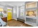 Bright entryway with built-in storage, hardwood floors, and a sunny yellow door at 423 State St, Charlotte, NC 28208
