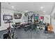 Workout room with stationary bike, weight machines, TV and mirror accent wall at 423 State St, Charlotte, NC 28208