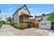 Exterior view of a home's backyard featuring a detached garage, a deck and a 2-car drive-under garage at 423 State St, Charlotte, NC 28208