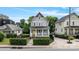 Charming two-story home featuring a welcoming front porch and a bright yellow front door at 423 State St, Charlotte, NC 28208