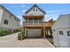 Two story home with gray siding, a screened in porch above the garage and driveway on the left at 423 State St, Charlotte, NC 28208