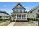 Inviting two-story home boasting a classic front porch and well-maintained landscaping at 423 State St, Charlotte, NC 28208