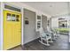 Inviting front porch with rocking chairs and a vibrant yellow door, perfect for relaxing at 423 State St, Charlotte, NC 28208