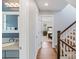 Hallway leading to bedroom featuring wood floors, stairs and vanity with decorative mirror at 423 State St, Charlotte, NC 28208