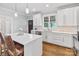 Bright kitchen with white cabinets, stainless steel appliances, a breakfast bar and hardwood floors at 423 State St, Charlotte, NC 28208