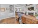 Stylish living room with hardwood floors, fireplace, and open view to the kitchen and dining area at 423 State St, Charlotte, NC 28208