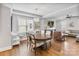 A stylish living room showcasing a fireplace, hardwood floors, and an elegant chandelier over the dining area at 423 State St, Charlotte, NC 28208