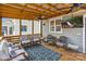 Inviting covered porch featuring comfortable seating, ceiling fans, a television and relaxing views at 423 State St, Charlotte, NC 28208