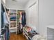 Spacious walk-in closet with built-in shelving, rods for hanging clothes, and natural light at 423 State St, Charlotte, NC 28208