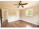 Cozy bedroom featuring hardwood floors and ample natural light from the window and ceiling fan at 462 Berry Hill Dr, Norwood, NC 28128