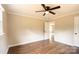 Well-lit bedroom with wood floors, ceiling fan, and bright windows at 462 Berry Hill Dr, Norwood, NC 28128