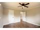 Bedroom features hardwood floors, a ceiling fan, and two doorways at 462 Berry Hill Dr, Norwood, NC 28128