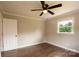 Bedroom features hardwood floors, a ceiling fan, and a window providing natural light at 462 Berry Hill Dr, Norwood, NC 28128