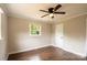 Bedroom with hardwood floors, a ceiling fan, window, and neutral paint at 462 Berry Hill Dr, Norwood, NC 28128