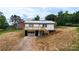 Charming home featuring a metal roof, deck, garage, and inviting curb appeal on a partially landscaped lot at 462 Berry Hill Dr, Norwood, NC 28128