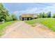 Charming two-story home with a drive-under garage and large wooden deck at 462 Berry Hill Dr, Norwood, NC 28128