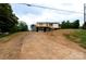 Charming home featuring a metal roof, deck, and garage nestled on a partially landscaped lot at 462 Berry Hill Dr, Norwood, NC 28128