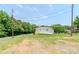 Side view of home, surrounded by green grass, trees and a paved street at 462 Berry Hill Dr, Norwood, NC 28128