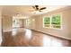 Bright living room with wood floors, ceiling fan, and open layout with deck and kitchen views at 462 Berry Hill Dr, Norwood, NC 28128