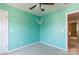 A quaint bedroom is painted in an inviting aquamarine hue with a ceiling fan at 4642 Laurendale Ct, Rock Hill, SC 29732