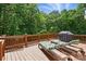 Spacious wooden deck with lounge chairs and a grill, great for entertaining at 4860 Sherborne Dr, Harrisburg, NC 28075
