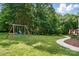 Expansive backyard features a swing set and room for outdoor activities at 4860 Sherborne Dr, Harrisburg, NC 28075
