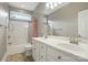 Bathroom featuring a double vanity with white cabinets, a shower-tub combo with neutral wall tiles at 4860 Sherborne Dr, Harrisburg, NC 28075