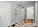 Modern bathroom showcasing a glass-enclosed shower with chrome fixtures and neutral tiling at 4860 Sherborne Dr, Harrisburg, NC 28075