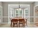 Cozy dining area with bay windows, pendant lighting, and classic wooden table set at 4860 Sherborne Dr, Harrisburg, NC 28075