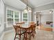 Inviting dining area with a charming chandelier and view of the living room at 4860 Sherborne Dr, Harrisburg, NC 28075