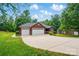 Well-maintained home featuring a three-car garage, long driveway, and mature trees in a lush setting at 4860 Sherborne Dr, Harrisburg, NC 28075