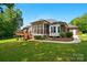 Beautiful backyard view of home with deck and screened-in porch at 4860 Sherborne Dr, Harrisburg, NC 28075