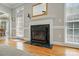 Fireplace with marble surround and view of the living room at 4860 Sherborne Dr, Harrisburg, NC 28075