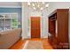 Elegant foyer featuring hardwood floors, a chandelier, and views into the living room at 4860 Sherborne Dr, Harrisburg, NC 28075