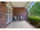 Inviting covered front porch furnished with seating and decorative pillows for a cozy outdoor space at 4860 Sherborne Dr, Harrisburg, NC 28075