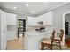 Charming kitchen with white cabinets, counter seating, and modern stainless steel appliances at 4860 Sherborne Dr, Harrisburg, NC 28075