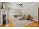 Comfortable living room with fireplace, hardwood floors, and natural light at 4860 Sherborne Dr, Harrisburg, NC 28075