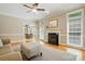 Spacious living room with fireplace, hardwood floors, and access to dining area at 4860 Sherborne Dr, Harrisburg, NC 28075