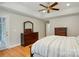 Beautiful primary bedroom with wood flooring, large window, and a dresser at 4860 Sherborne Dr, Harrisburg, NC 28075