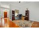 Inviting home office features hardwood floors, a ceiling fan and built-in bookcases at 4860 Sherborne Dr, Harrisburg, NC 28075