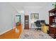 Bright home office with colorful rug, built-in shelving, and natural light at 4860 Sherborne Dr, Harrisburg, NC 28075