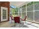 Comfortable screened-in porch with stylish furniture overlooking the backyard at 4860 Sherborne Dr, Harrisburg, NC 28075
