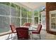 Cozy screened porch with seating area and view of backyard at 4860 Sherborne Dr, Harrisburg, NC 28075