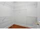 Practical walk-in closet with white wire shelving and hardwood floors at 4860 Sherborne Dr, Harrisburg, NC 28075