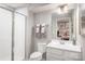 Clean bathroom with white vanity, toilet, framed mirror, and a walk-in shower at 518 Durango Way, Denver, NC 28037