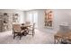 Open dining room area with neutral walls, carpet, and a round wood table with chairs at 518 Durango Way, Denver, NC 28037