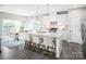 A stylish kitchen with white cabinets, granite countertops, stainless steel appliances, and an island with bar seating at 518 Durango Way, Denver, NC 28037