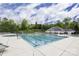 Community pool with an olympic size area, and a hot tub surrounded by greenery at 518 Durango Way, Denver, NC 28037